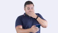 A shocked man sees something NSFW on his phone.